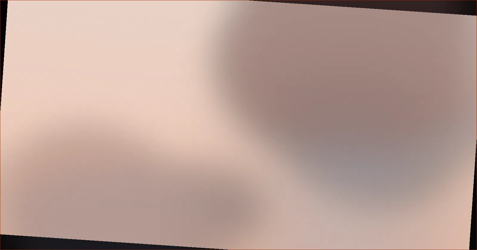 Person closing a laptop at a tidy desk beside a handwritten checklist in early evening light
